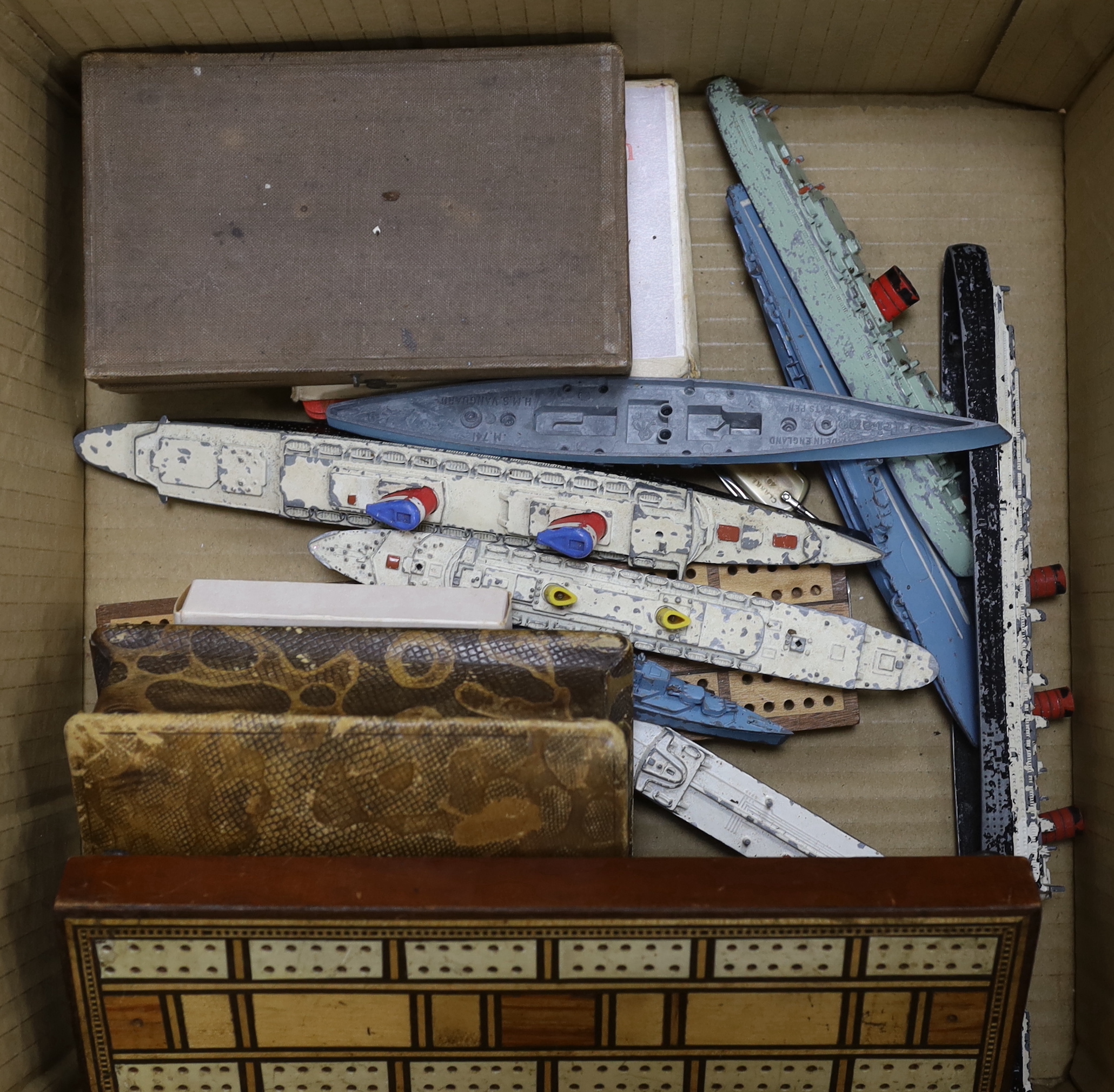 A quantity of toys including Dinky, Pelham puppet and cribbage board, the largest 38cm wide
